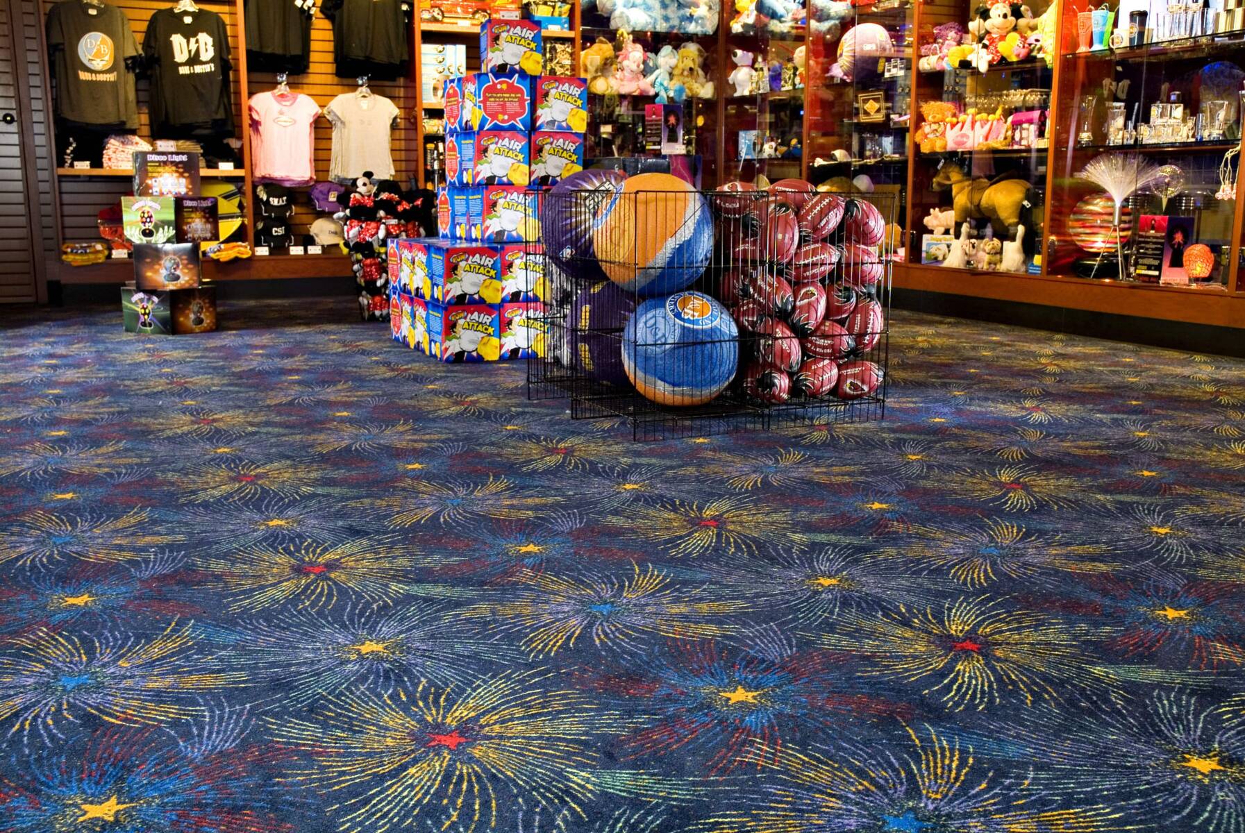 Dave and Busters gift shop filled with many toys and a colorful themed carpet demonstrating commercial flooring expertise