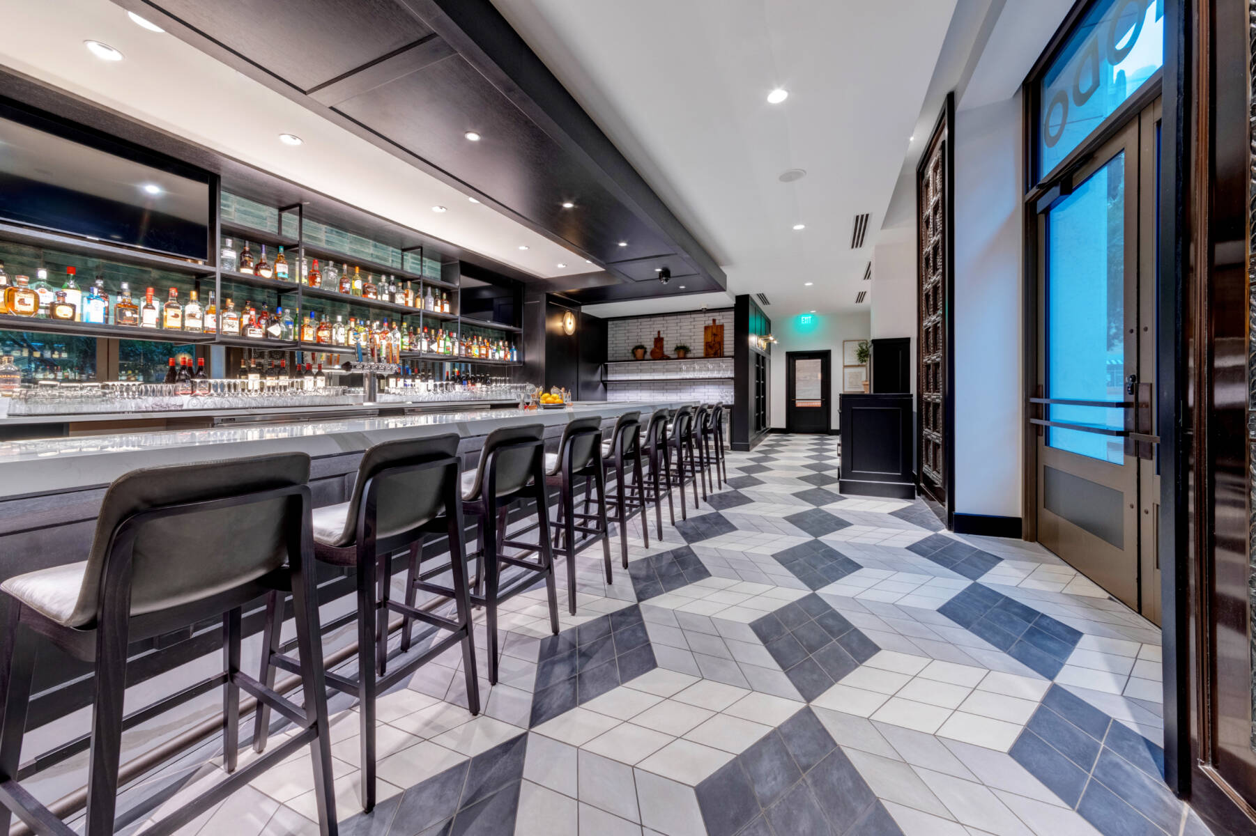Choctaw Casino & Resort Harper Hotel Bar Area. Geometric flooring tile pattern illustrates flooring installation superiority.