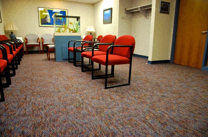 Alexian Brothers Wimmer Building’s waiting room accompanied by masculine color palette flooring with Mannington carpet tile